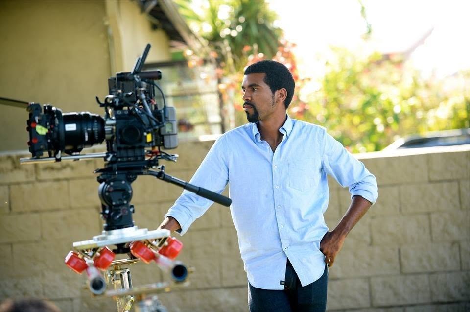 Christopher LaVan on set, standing beside a RED camera rig.